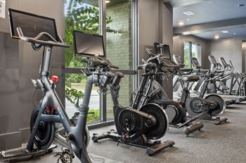 Cardio and strength training fitness center with eschelon and peloton bikes and fitness mirrors